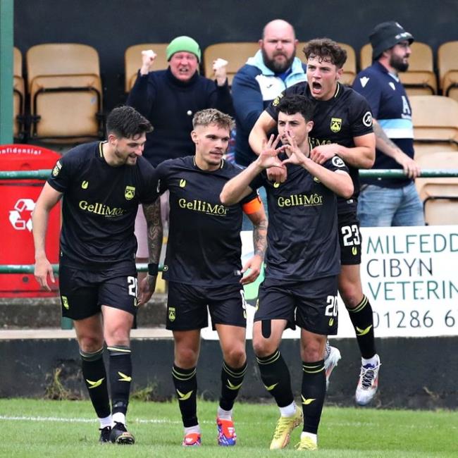 Owain Jones celebrates scoring a late winner with teammates